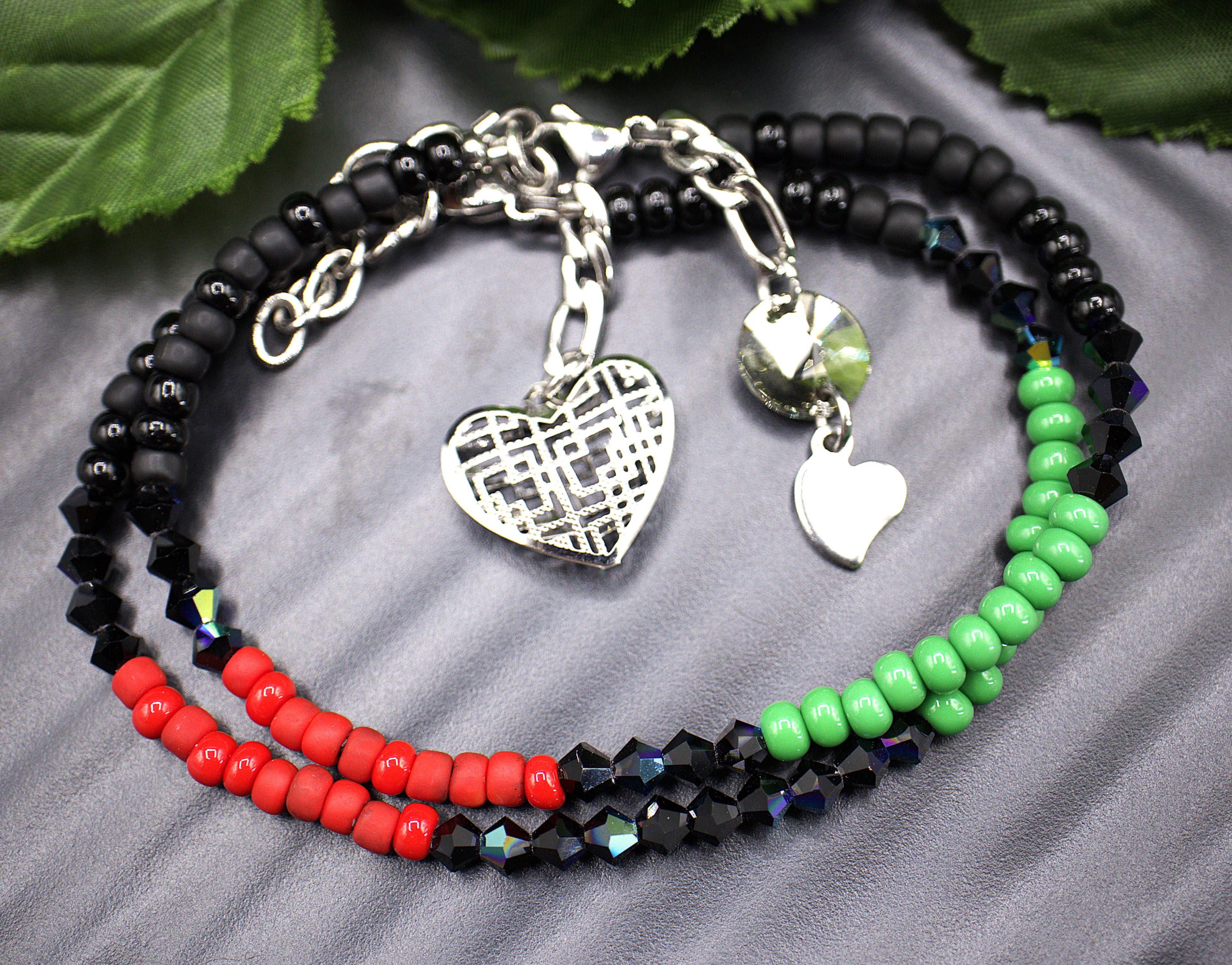  Dainty beaded 4mm tennis bracelet, with a dangling light weight large heart charm. Each aurora borealis crystal was placed to showcase every facet. Each bracelet is exquisite in its own right but stacking the bracelets makes them astonishing. Bracelet finishes are stainless steel making them hypoallergenic. All beaded bracelets are handmade demonstrating unique craftsmanship. 

   These gorgeous bracelets comes in five complimenting designs and five stunning colors, white and gold (Margo) , red aurora bore