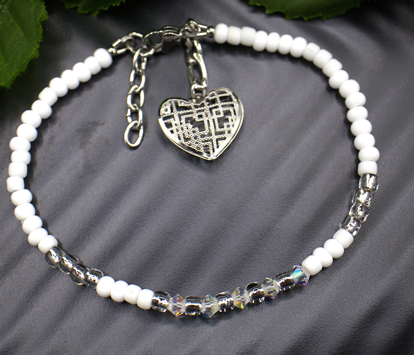  Dainty beaded 4mm tennis bracelet, with a dangling light weight large heart charm. Each aurora borealis crystal was placed to showcase every facet. Each bracelet is exquisite in its own right but stacking the bracelets makes them astonishing. Bracelet finishes are stainless steel making them hypoallergenic. All beaded bracelets are handmade demonstrating unique craftsmanship. 

   These gorgeous bracelets comes in five complimenting designs and five stunning colors, white and gold (Margo) , red aurora bore
