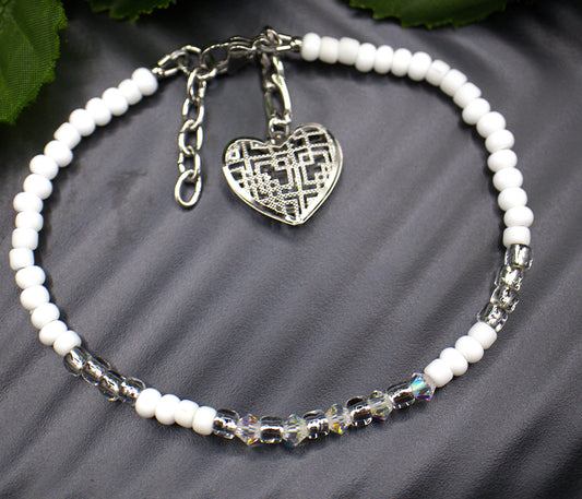  Dainty beaded 4mm tennis bracelet, with a dangling light weight large heart charm. Each aurora borealis crystal was placed to showcase every facet. Each bracelet is exquisite in its own right but stacking the bracelets makes them astonishing. Bracelet finishes are stainless steel making them hypoallergenic. All beaded bracelets are handmade demonstrating unique craftsmanship. 

   These gorgeous bracelets comes in five complimenting designs and five stunning colors, white and gold (Margo) , red aurora bore