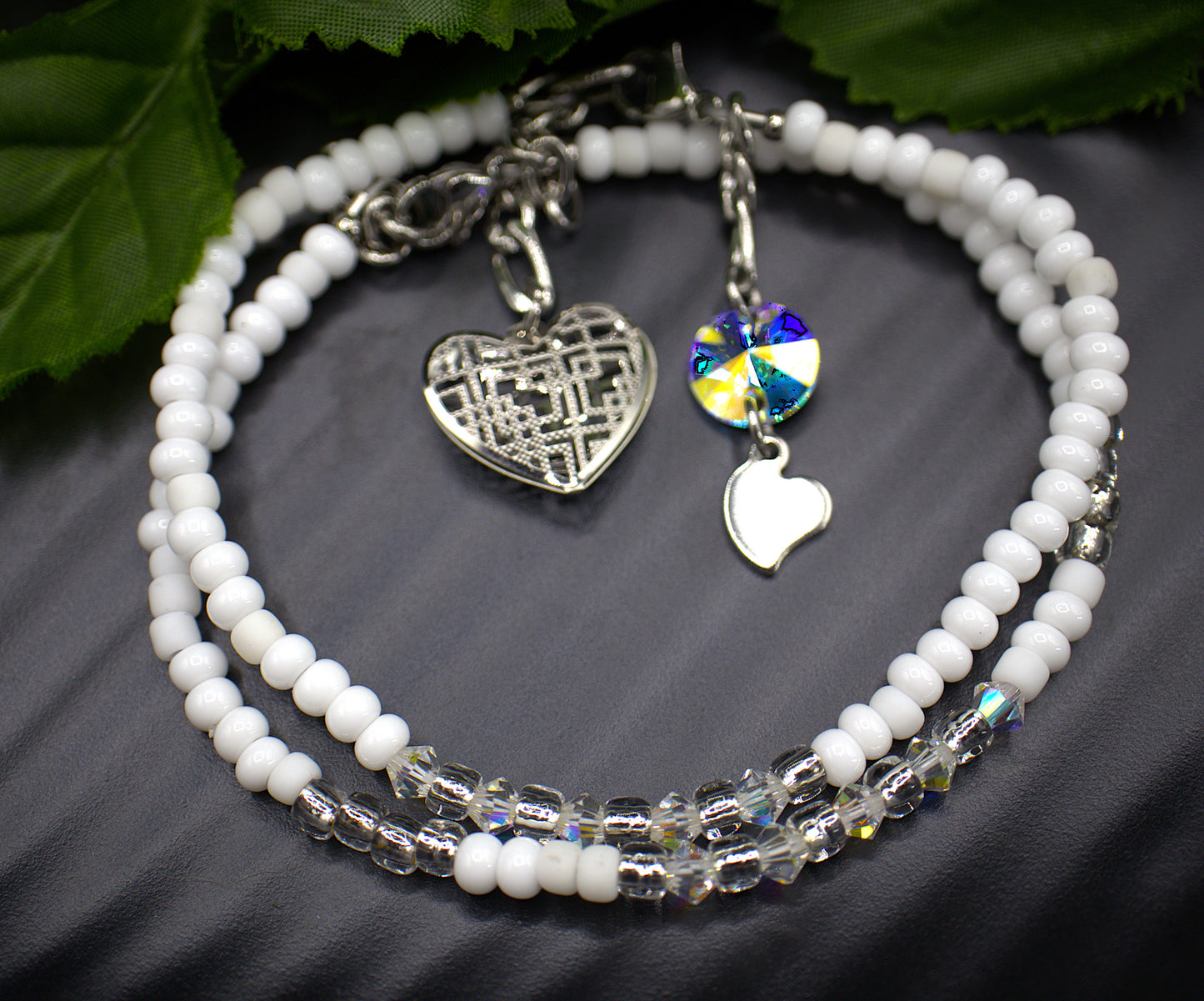  Dainty beaded 4mm tennis bracelet, with a dangling light weight large heart charm. Each aurora borealis crystal was placed to showcase every facet. Each bracelet is exquisite in its own right but stacking the bracelets makes them astonishing. Bracelet finishes are stainless steel making them hypoallergenic. All beaded bracelets are handmade demonstrating unique craftsmanship. 

   These gorgeous bracelets comes in five complimenting designs and five stunning colors, white and gold (Margo) , red aurora bore