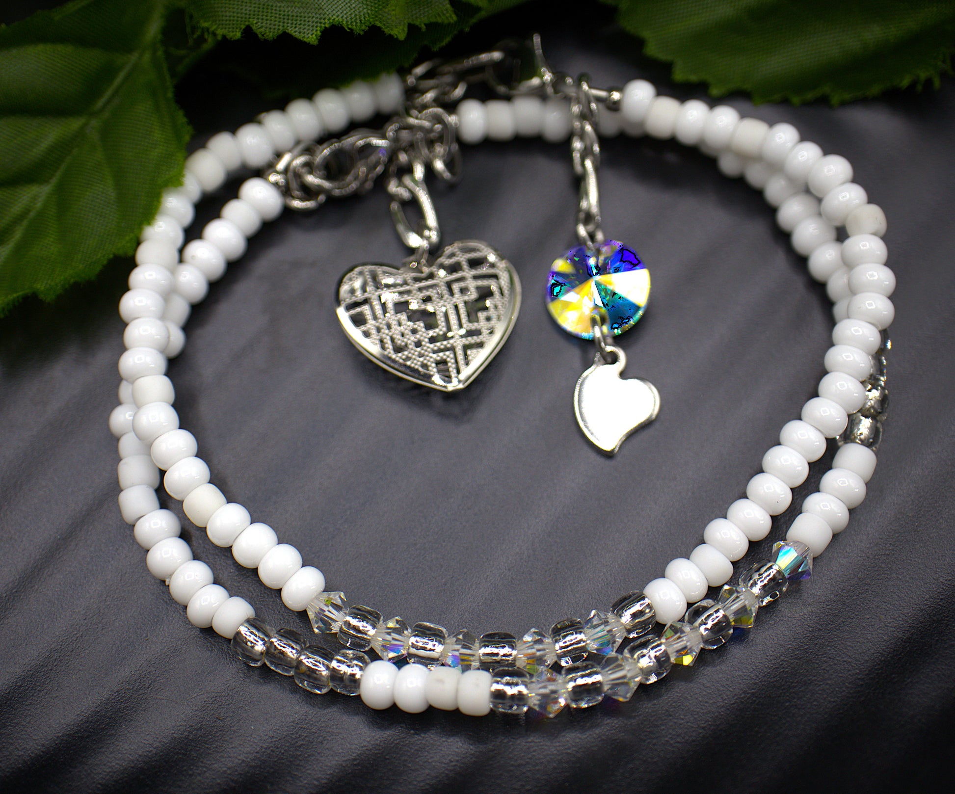  Dainty beaded 4mm tennis bracelet, with a dangling light weight large heart charm. Each aurora borealis crystal was placed to showcase every facet. Each bracelet is exquisite in its own right but stacking the bracelets makes them astonishing. Bracelet finishes are stainless steel making them hypoallergenic. All beaded bracelets are handmade demonstrating unique craftsmanship. 

   These gorgeous bracelets comes in five complimenting designs and five stunning colors, white and gold (Margo) , red aurora bore